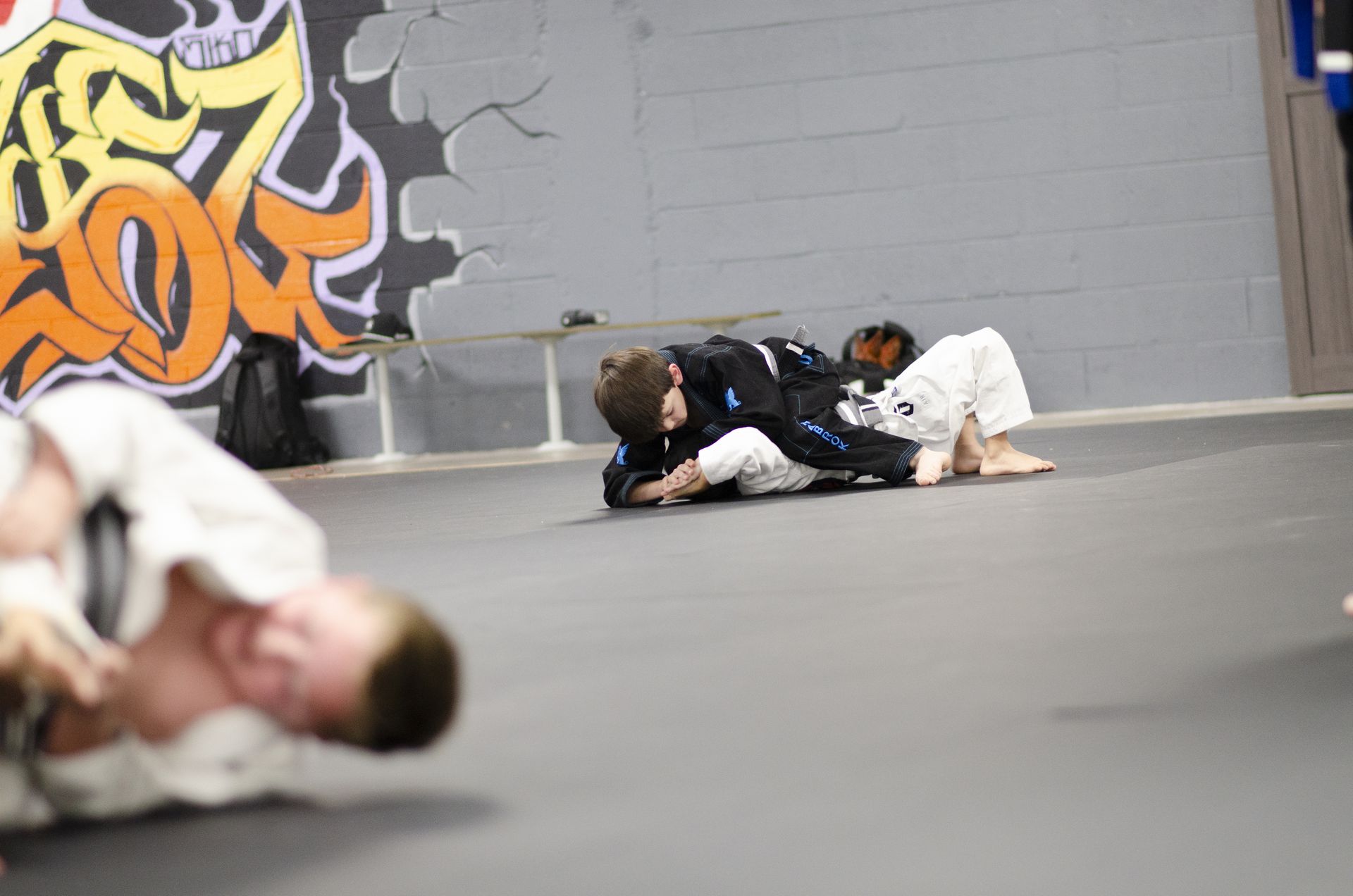 Students training in front of the mural at Second Grip Jiu Jitsu in Carlsbad, New Mexico